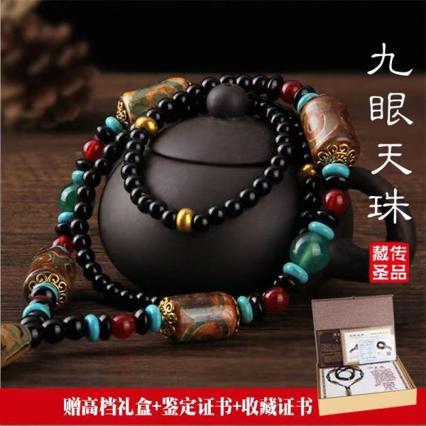 Close-up of Nine-Eye Dzi Bead pendant showcasing intricate Tibetan agate carvings for wealth and protection.