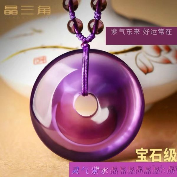 Close-up of natural amethyst Peace Knot pendant radiating spiritual energy for wealth and protection.