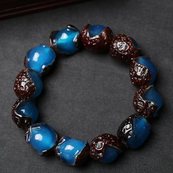Close-up of rare Blue Amber beads with weathered ‘old-skin’ texture, radiating calming energy.