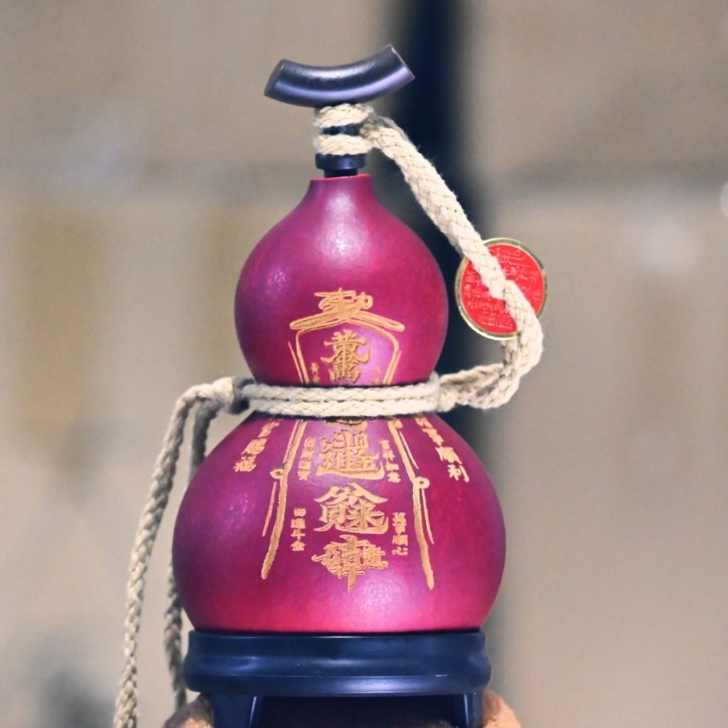 Hand-carved red lacquer gourd with cinnabar Five Thunder symbols, radiating wealth energy and protection.