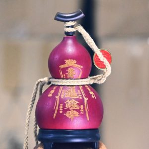Hand-carved red lacquer gourd with cinnabar Five Thunder symbols, radiating wealth energy and protection.