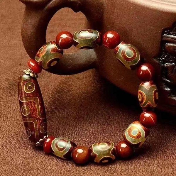Handcrafted dzi bead bracelet with Buddhist mala design, perfect for meditation and Feng Shui harmony.