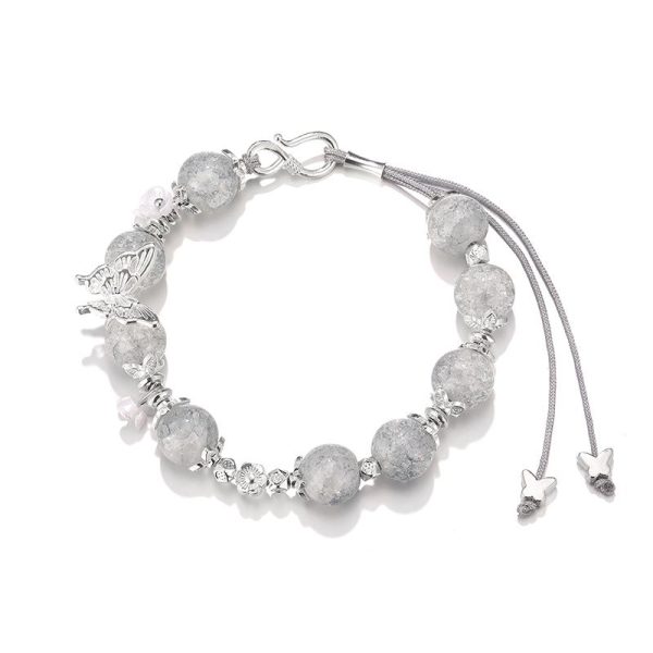 Handmade adjustable bracelet featuring delicate butterflies, ideal for gifting or personal energy balance.