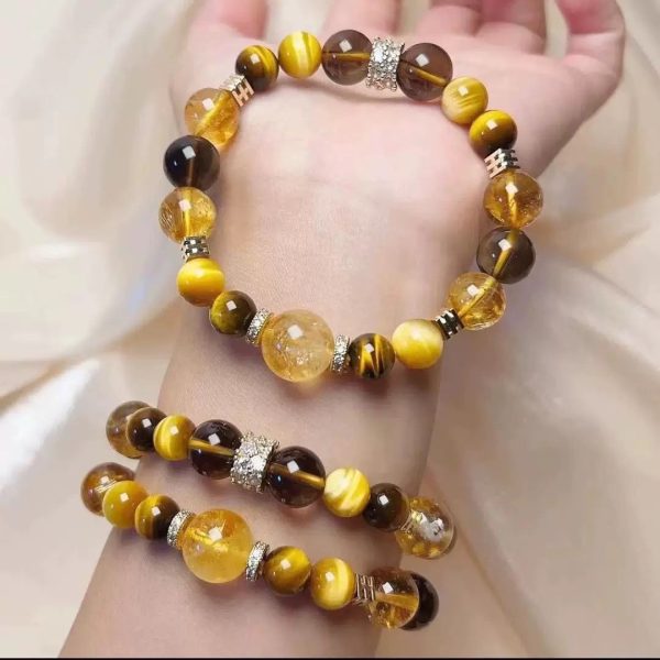 Macro shot of gold beads reflecting light, emphasizing their role in amplifying prosperity energy.