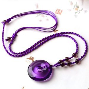 Stylish model wearing the amethyst pendant, showcasing its versatility as daily protection and prosperity charm.