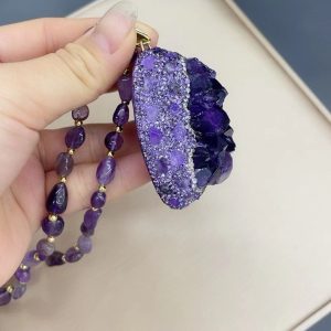 Woman wearing an amethyst necklace, embodying confidence and positive energy.