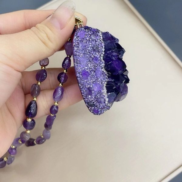 Woman wearing an amethyst necklace, embodying confidence and positive energy.