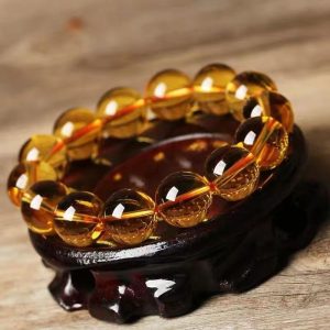 Vibrant natural yellow citrine beads glowing with wealth-attracting energy in a handcrafted bracelet