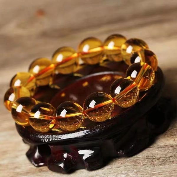 Vibrant natural yellow citrine beads glowing with wealth-attracting energy in a handcrafted bracelet