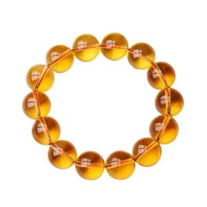 wearing a citrine bracelet at her workspace, invoking abundance and focus