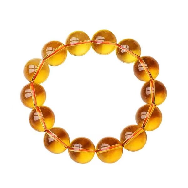 wearing a citrine bracelet at her workspace, invoking abundance and focus